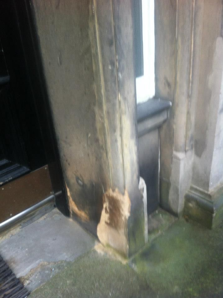 Cracked stone door frame repair by Edinburgh stonemasons, restoring historic building integrity.