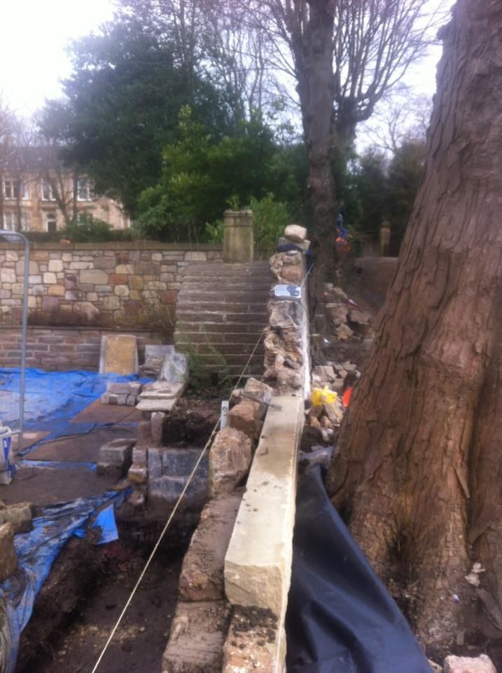 Old stone garden wall restoration by IMC Stonemasons Edinburgh.