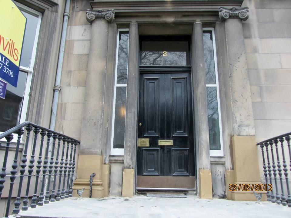 Elegant black stone front door with classic architectural details, crafted by IMC Stonemasons Ltd in Edinburgh.