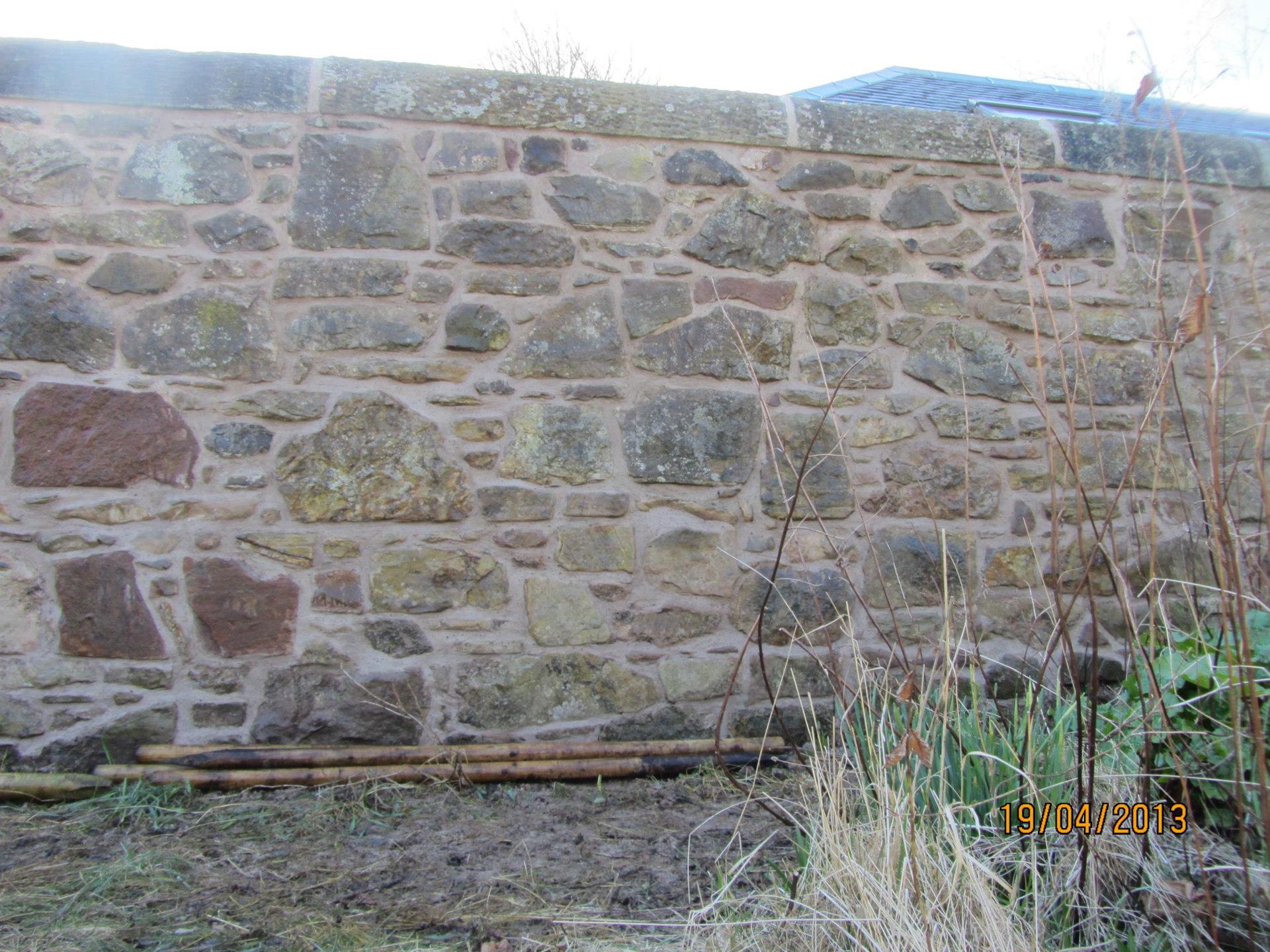 Weathered stone wall built by expert Edinburgh stonemasons for historic and garden restoration projects.