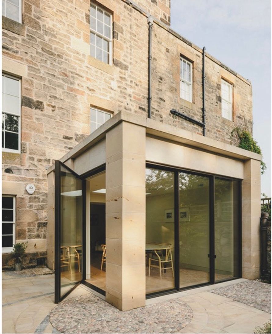 Elegant stone extension with large glass doors at historic Edinburgh building, crafted by IMC Stonemasons Ltd.